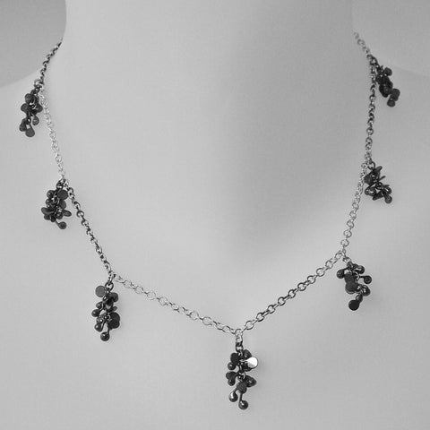 Harmony charm Necklace, oxidised silver by Fiona DeMarco